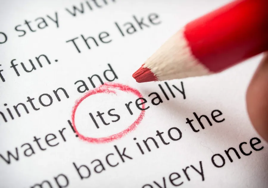 A spelling error being circled in red while Proofreading a document