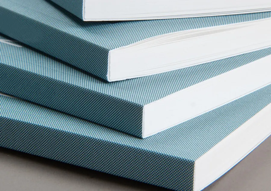 A stack of four books with Perfect Binding