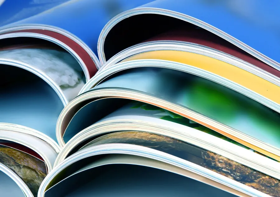 A stack of colorful magazines with Heavy Ink Coverage