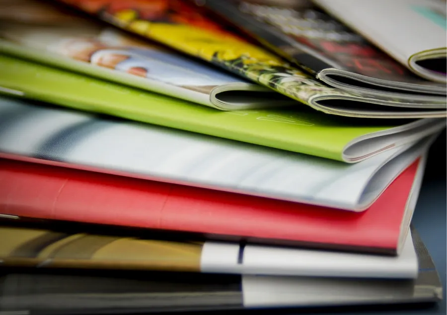 A variety of Saddle Stitched books arranged on a table