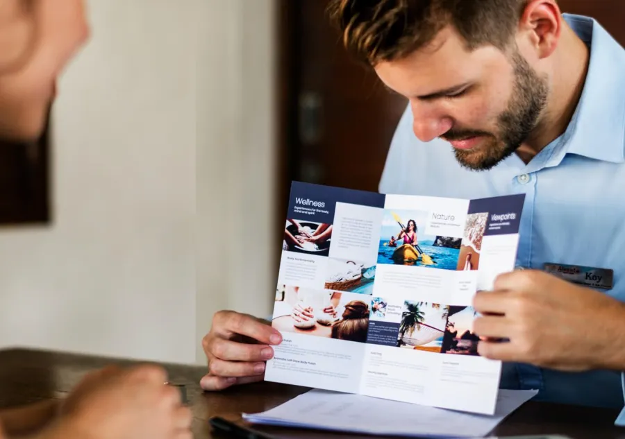 A salesman showing a Tri-fold Brochure to a client