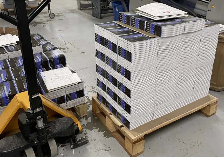 A large volume of perfect bound books at a print facility