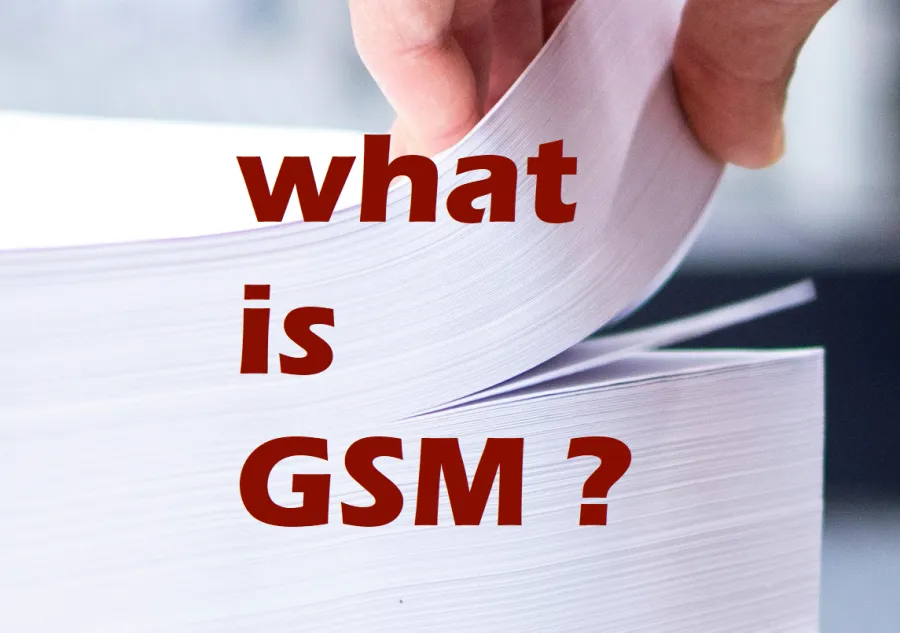 A hand flipping through a stack of paper with the title What is GSM?