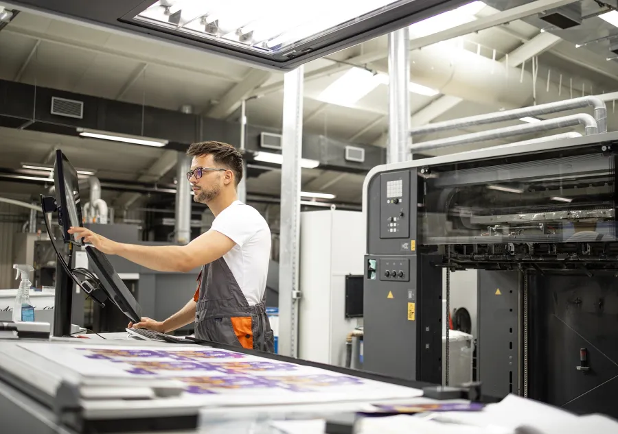 A press operator working in a printing factory