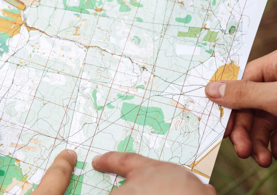 Hands holding a printed map