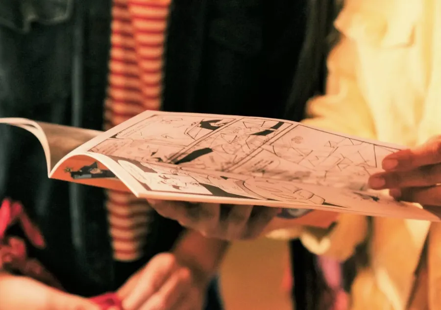 Two people looking through a Comic Book