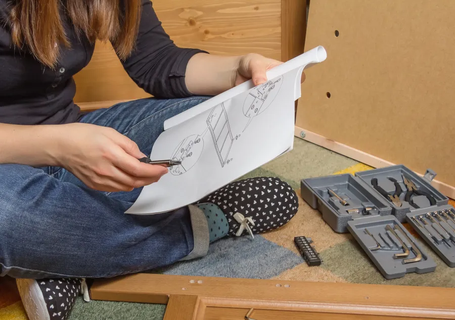 A young woman reading a Product Assembly Manual
