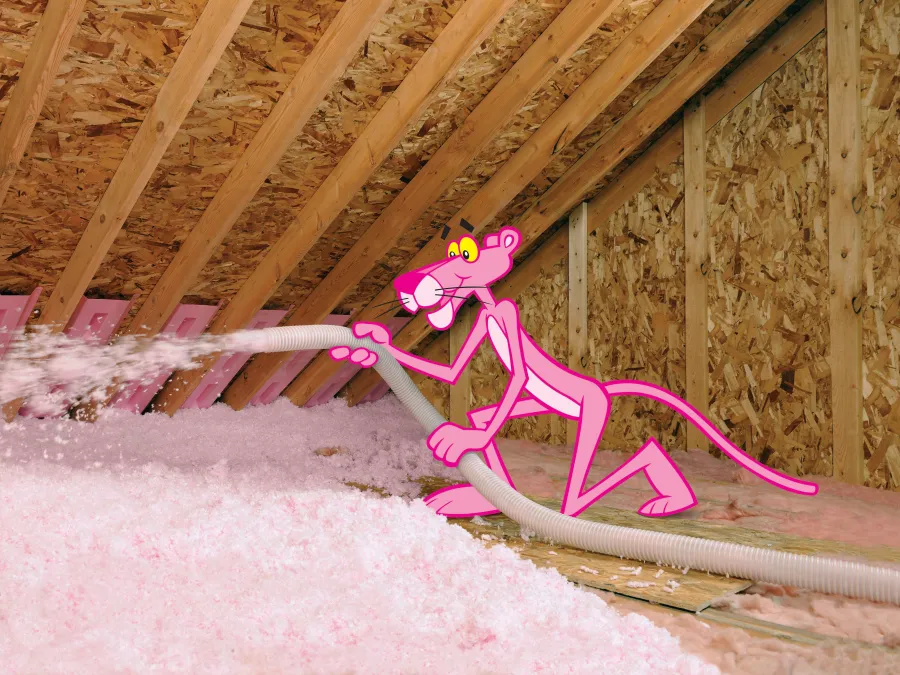 a pink ribbon tied to a wooden fence