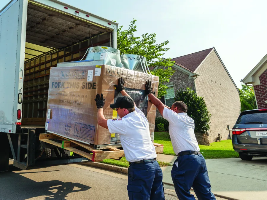 men loading a truck with boxes