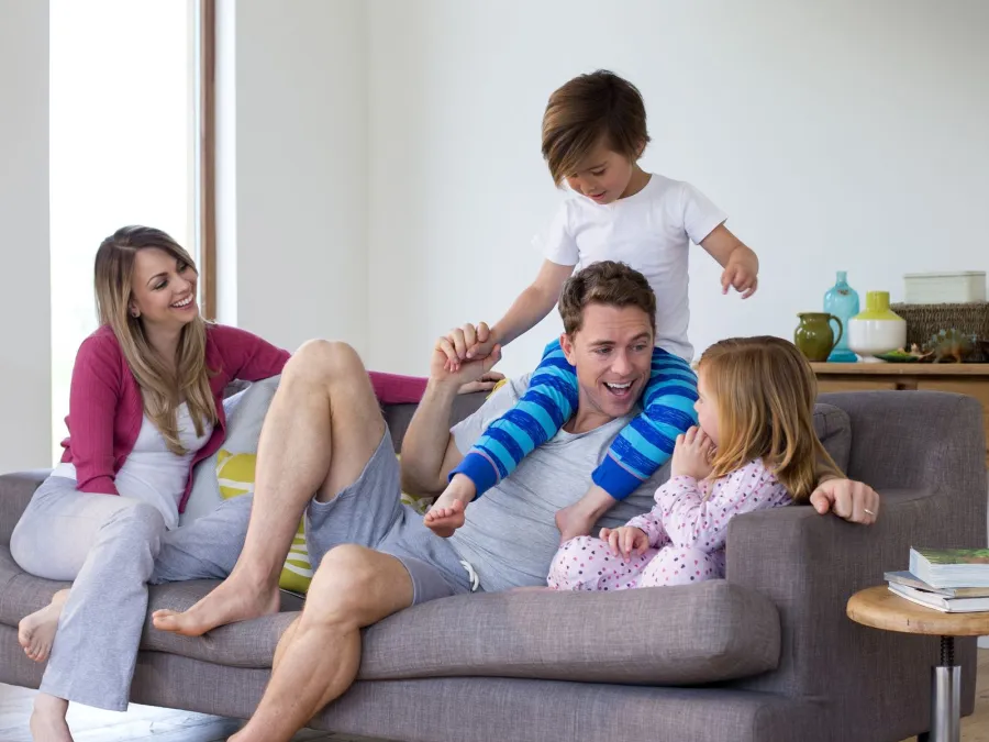 a family sitting on a couch