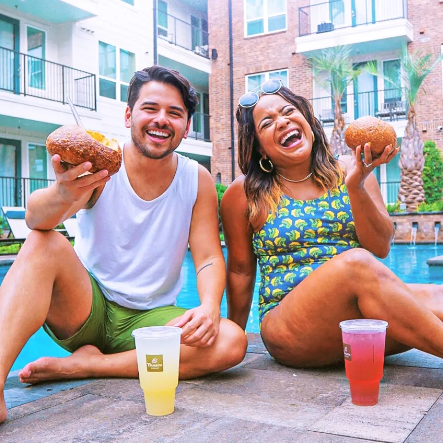 a man and woman eating donuts