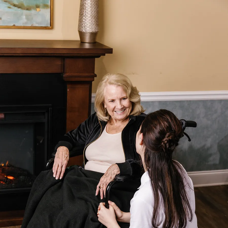 a person sitting on another woman's lap