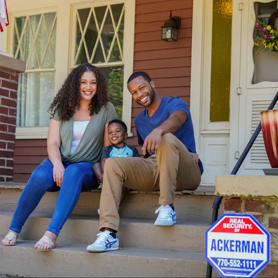 a family sitting on a porch with a child