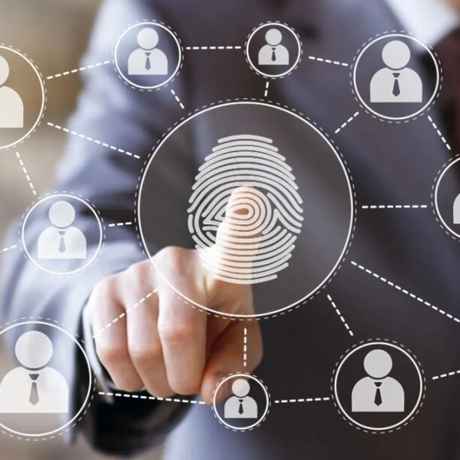 Businessman pointing at digital fingerprint connected to multiple user icons representing network security and identity verification.