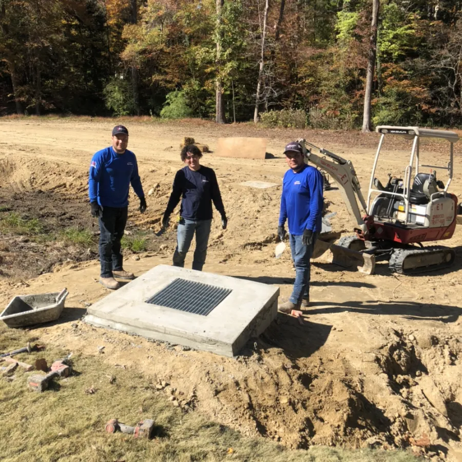 a group of people standing next to a machine outside