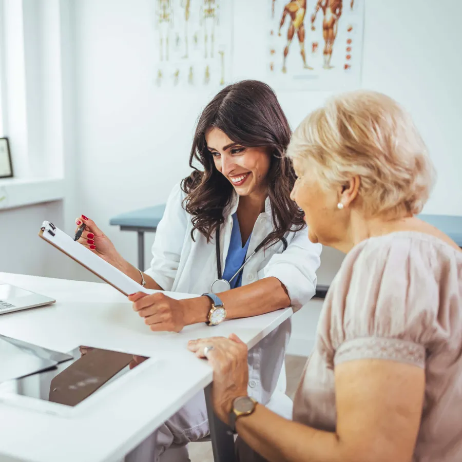 a woman showing a woman something on the paper