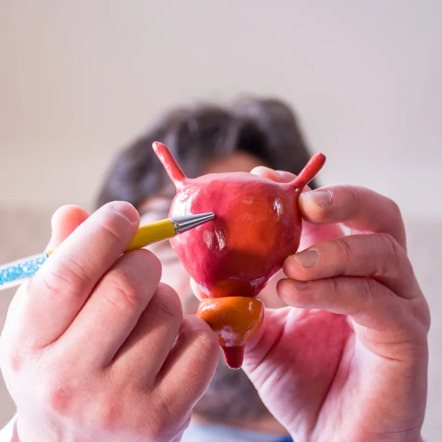 a person painting a red apple