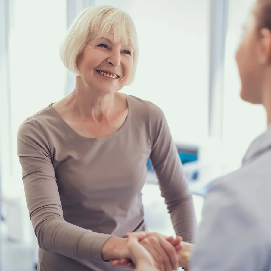 a woman shaking hands with another woman