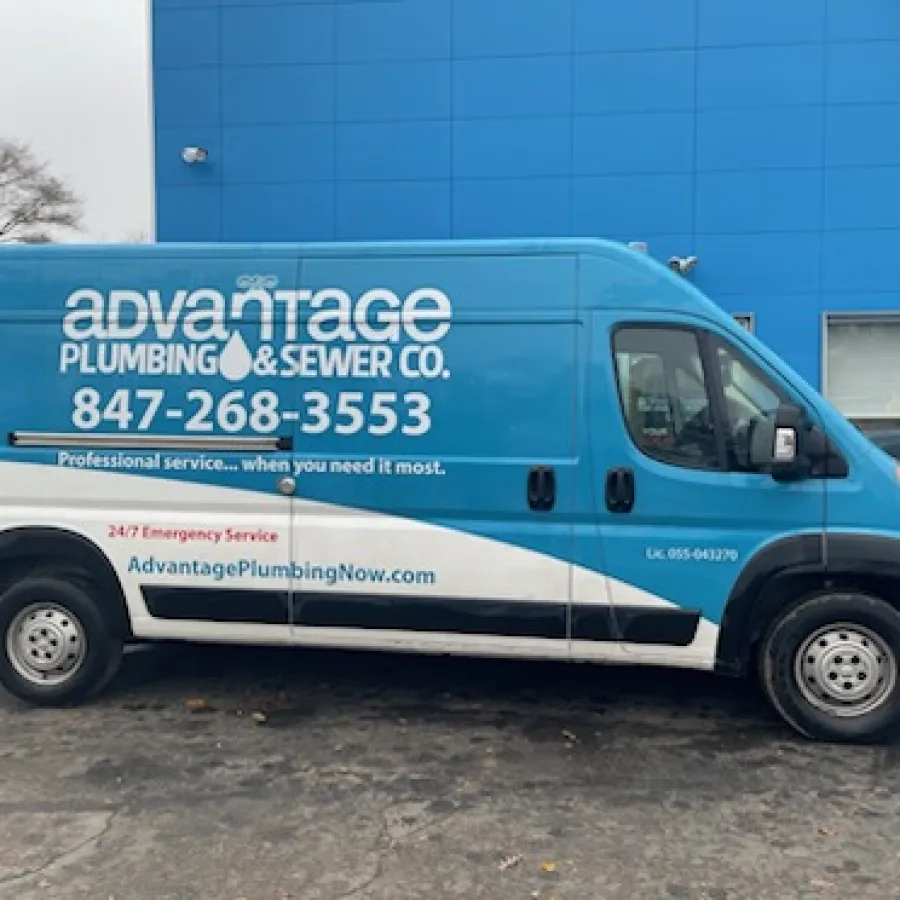 Blue and white Advantage Plumbing & Sewer Co. service van parked outside a blue building with contact details visible.