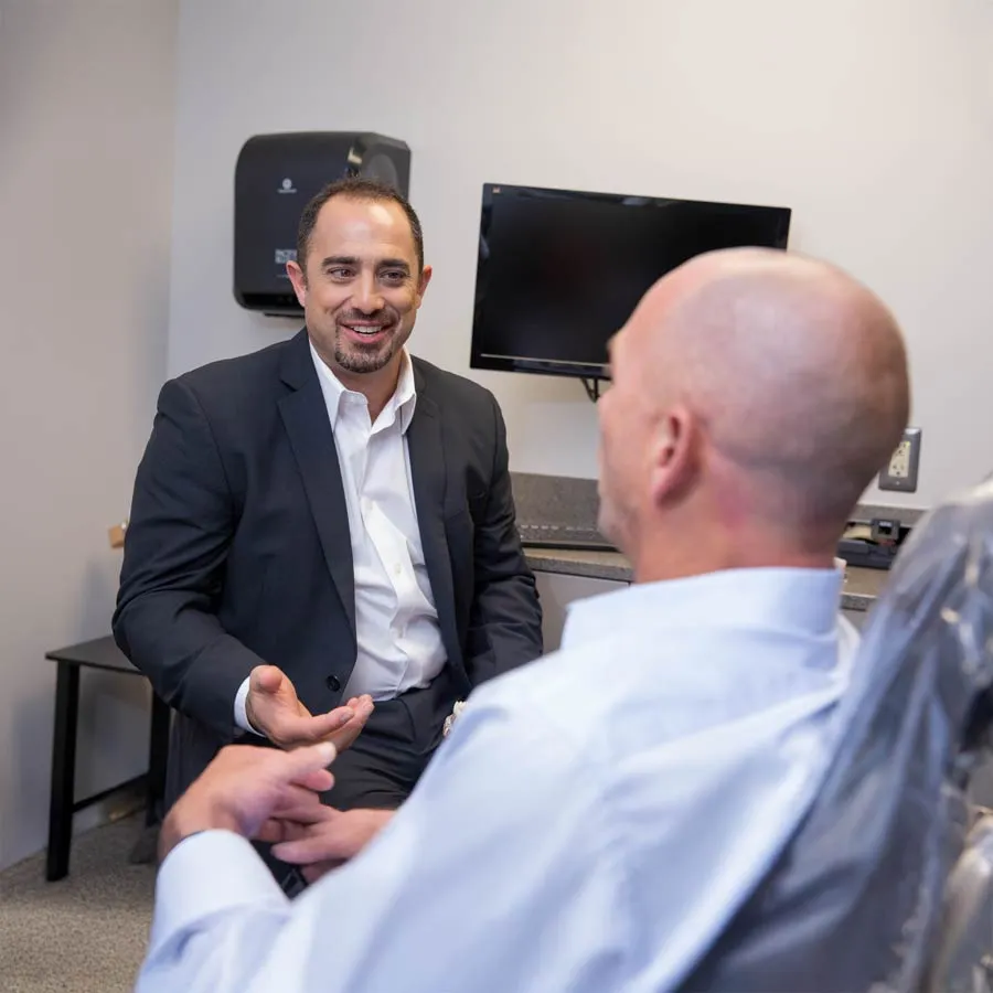 A dentist consulting with a patient in a clinic, emphasizing friendly communication and care.