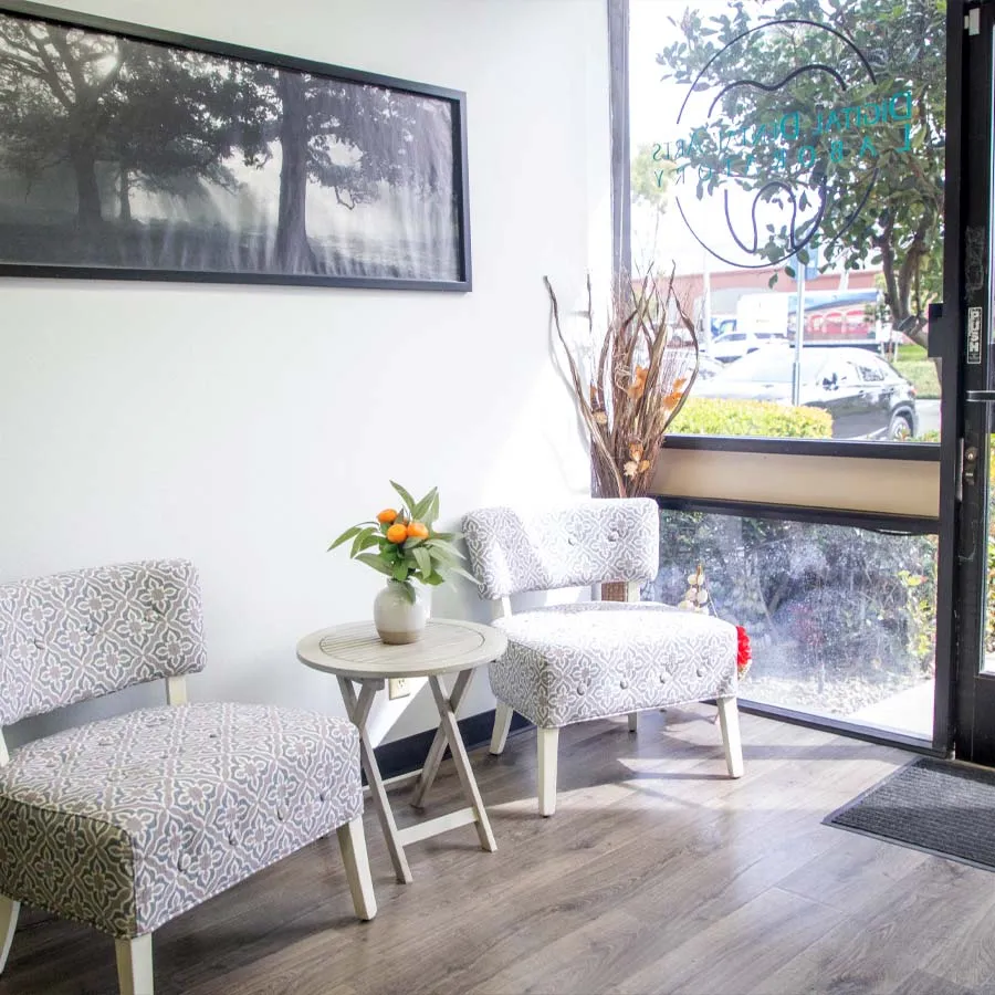 a living room with a table and chairs