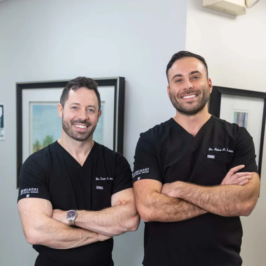 Dr. Nahed A. Lakkis with Dr. Sean M. Langton posing cross-armed inside Belmont Dental Group office