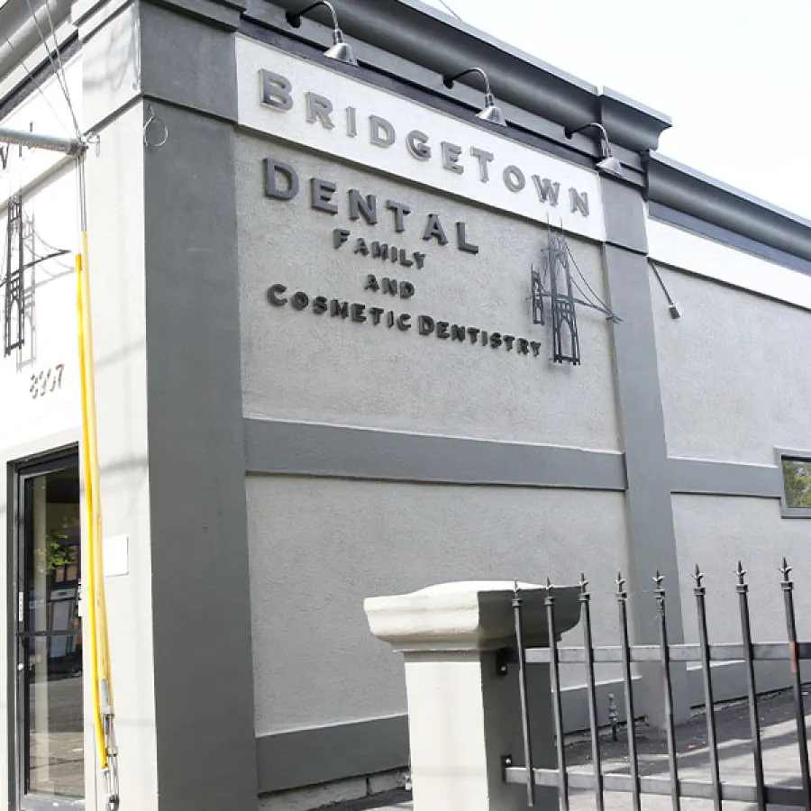 Exterior view of Bridgetown Dental, showcasing its signage and architectural details on a sunny day.