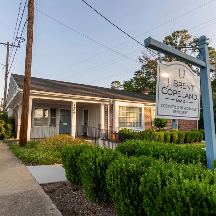 Exterior view of J. Brent Copeland cosmetic and restorative dentistry office with signage and greenery.