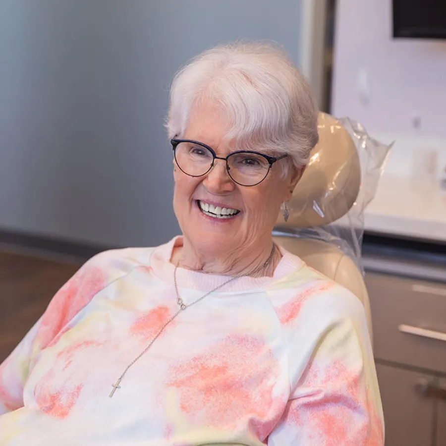 Smiling female healthcare professional talking to a male patient in a clinical setting