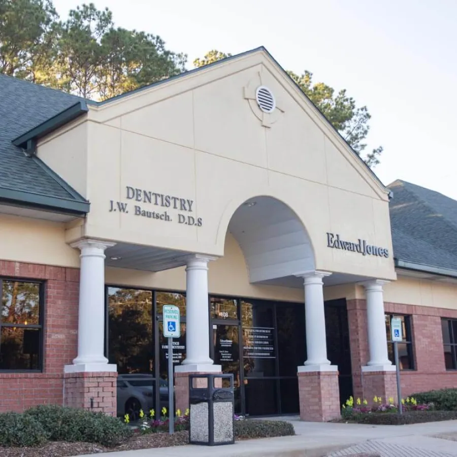 Commercial building with dental office and Edward Jones financial services, featuring pillars and accessible parking.