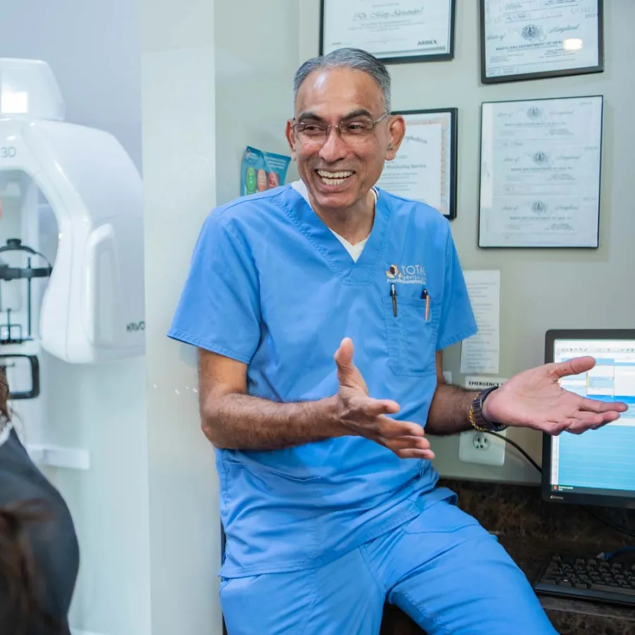 a woman smiling with her hand on her chin