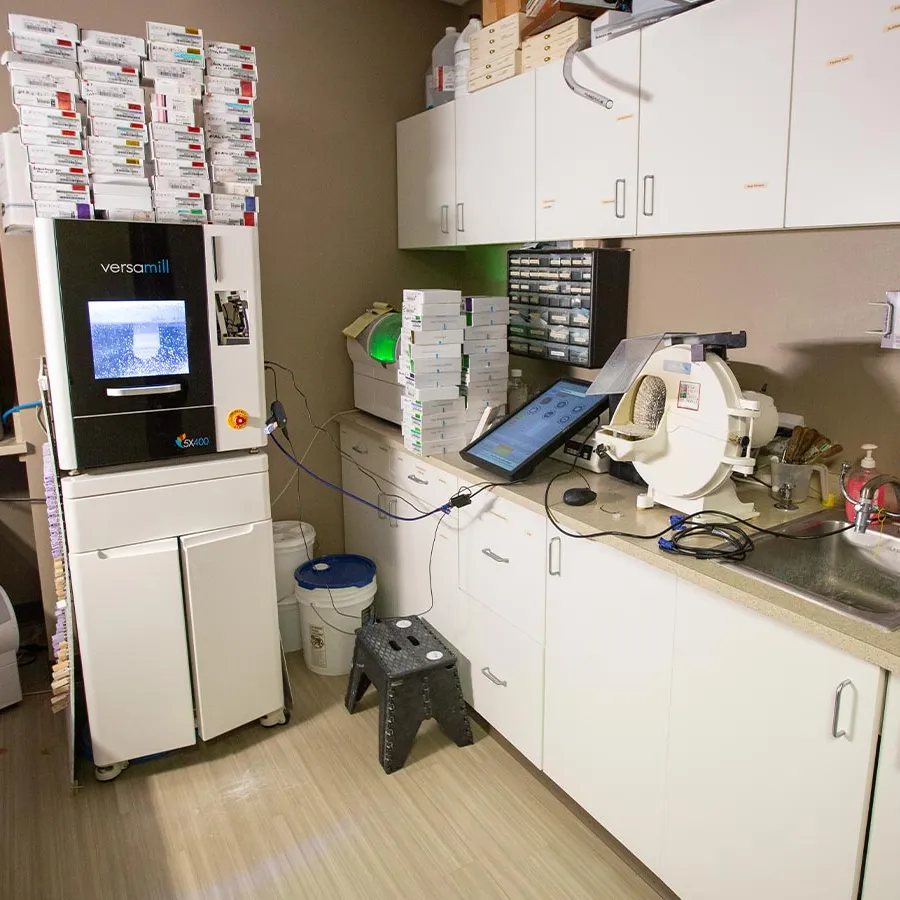 a kitchen with a computer and other objects on the counter