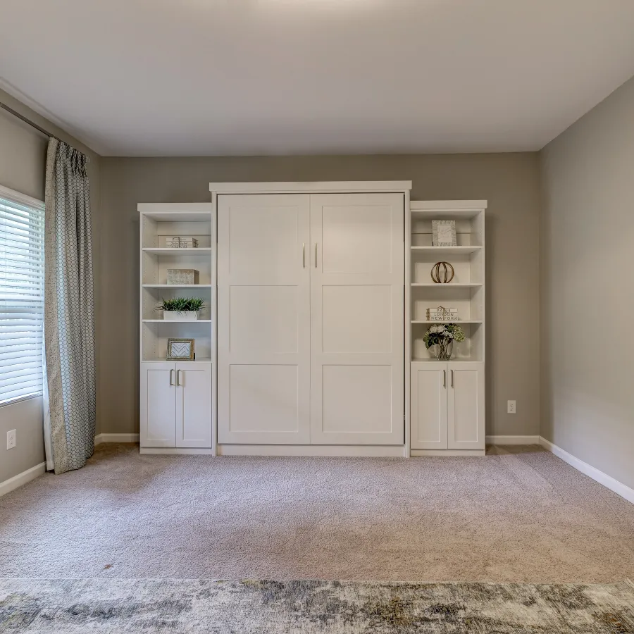 a room with a white cabinet and white walls