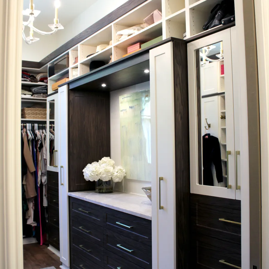 a closet with a mirror and a flower in it