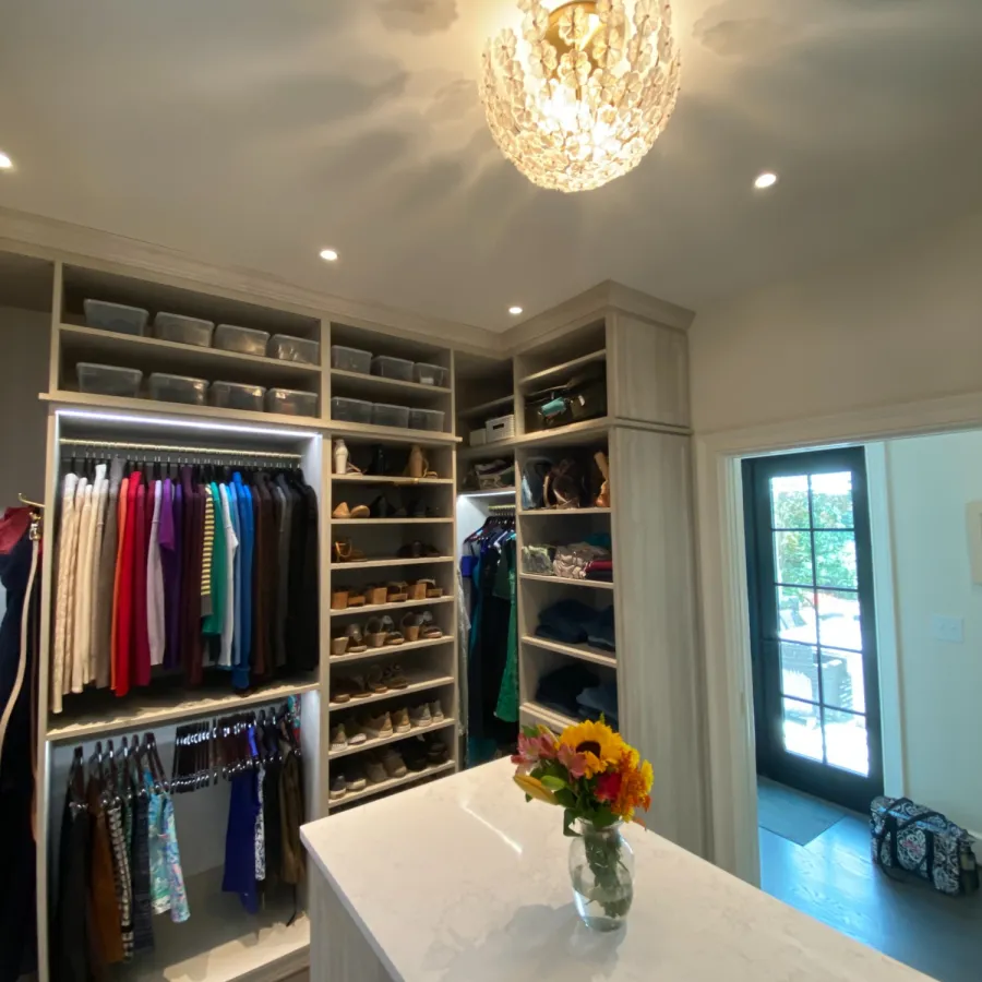 a room with a table and shelves with flowers