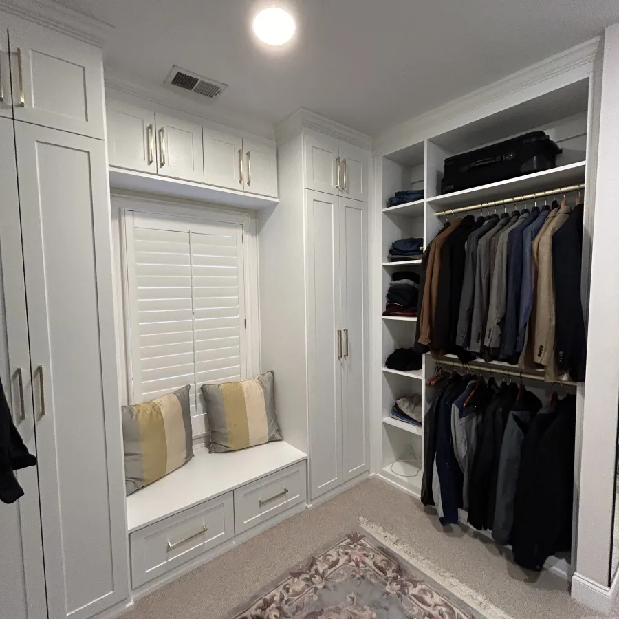 a closet with a mirror and a rug