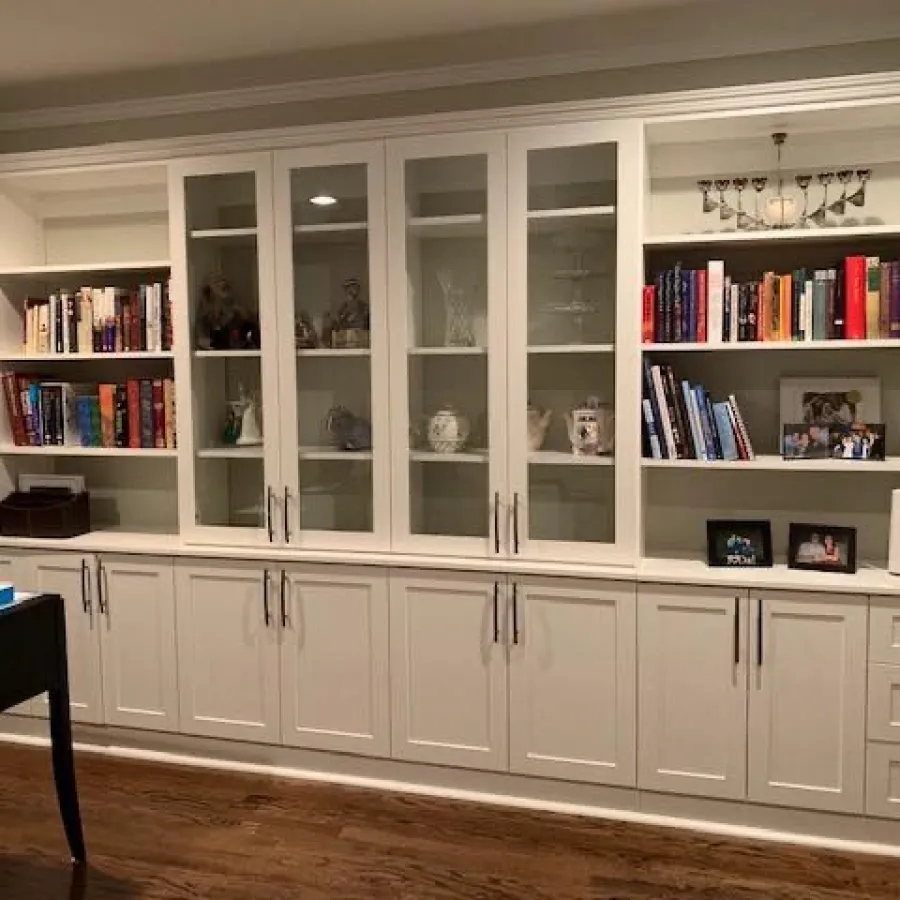 a white shelving unit with books