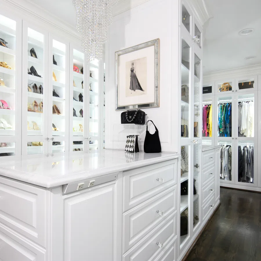 Luxurious walk-in closet featuring elegant shoes, a chic vanity, and organized clothing racks.
