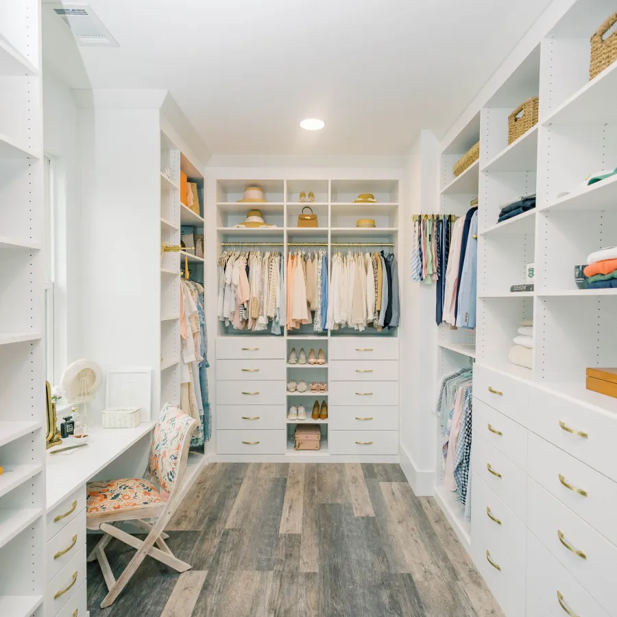 a room with white shelves and a chair