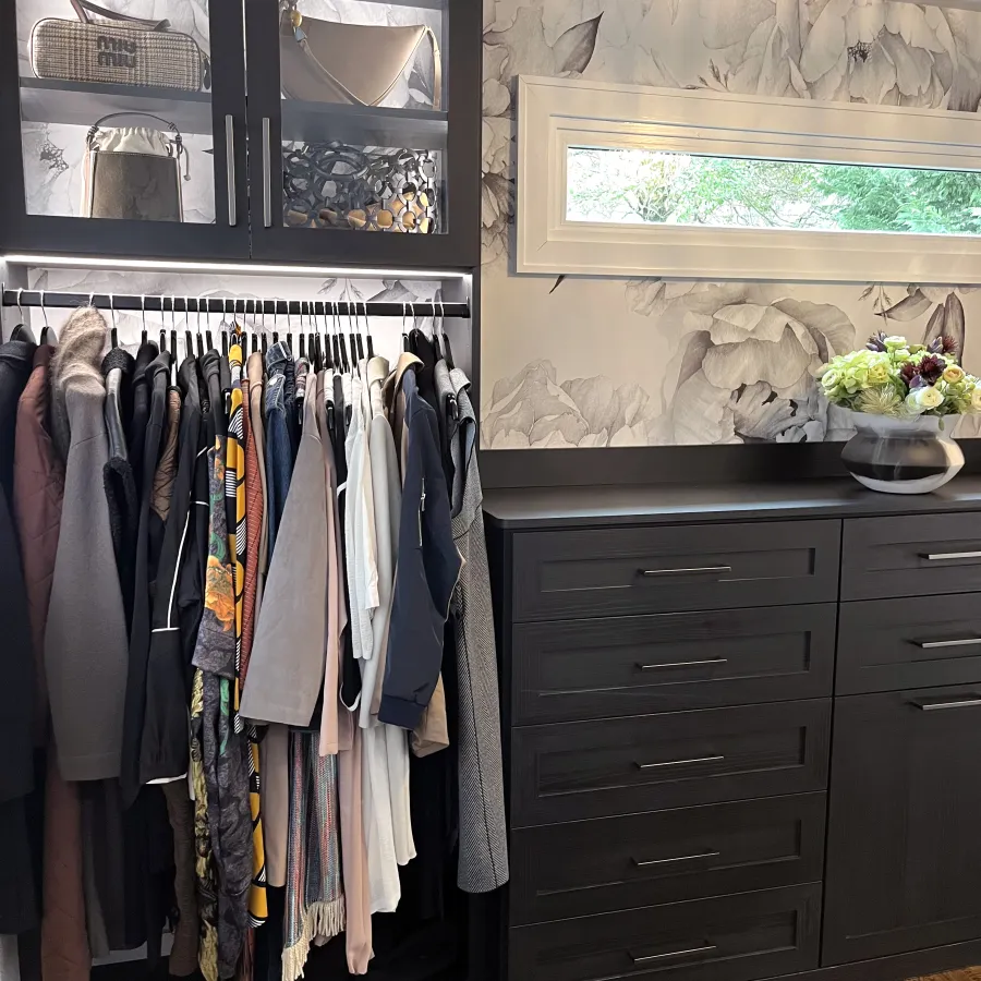 a closet with clothes and a mirror