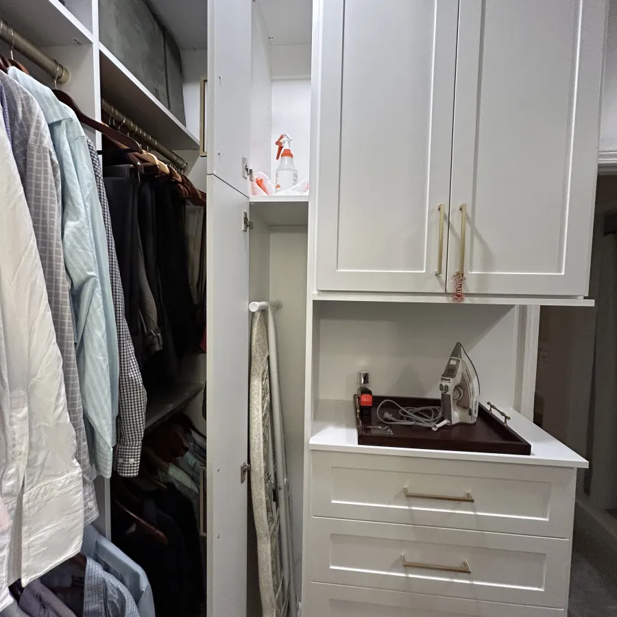 a closet with white cabinets