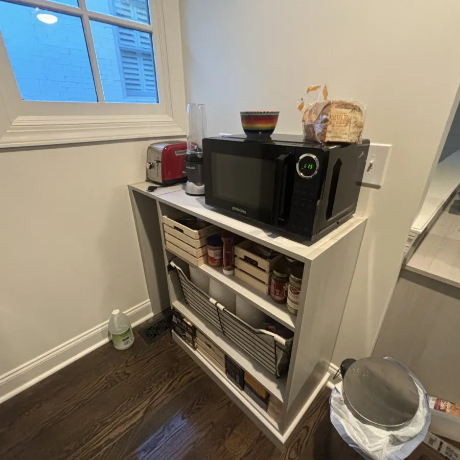 a microwave oven on a shelf