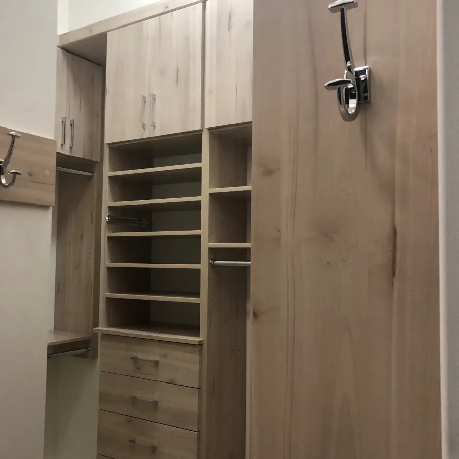 a wooden closet with a door