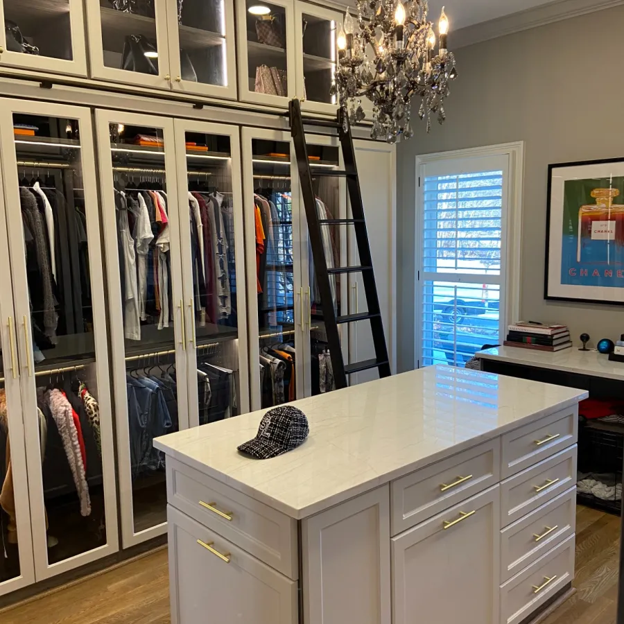 a room with a glass shelf and a white cabinet with a plant on it