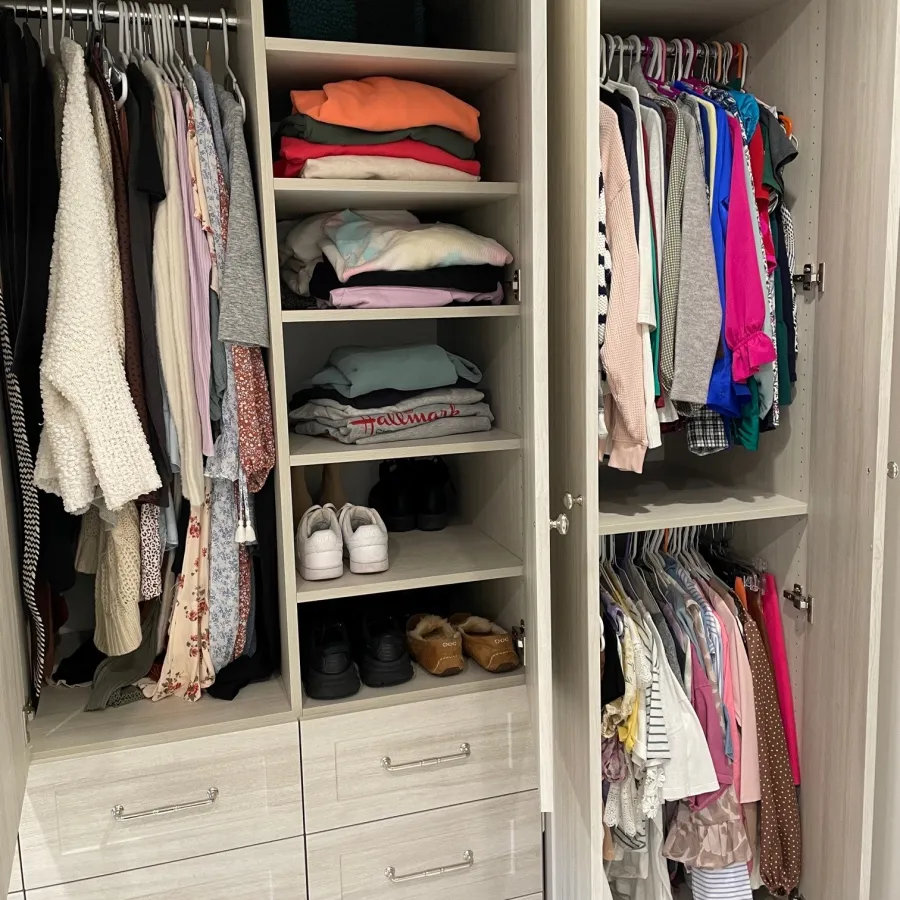 a closet with clothes and shoes