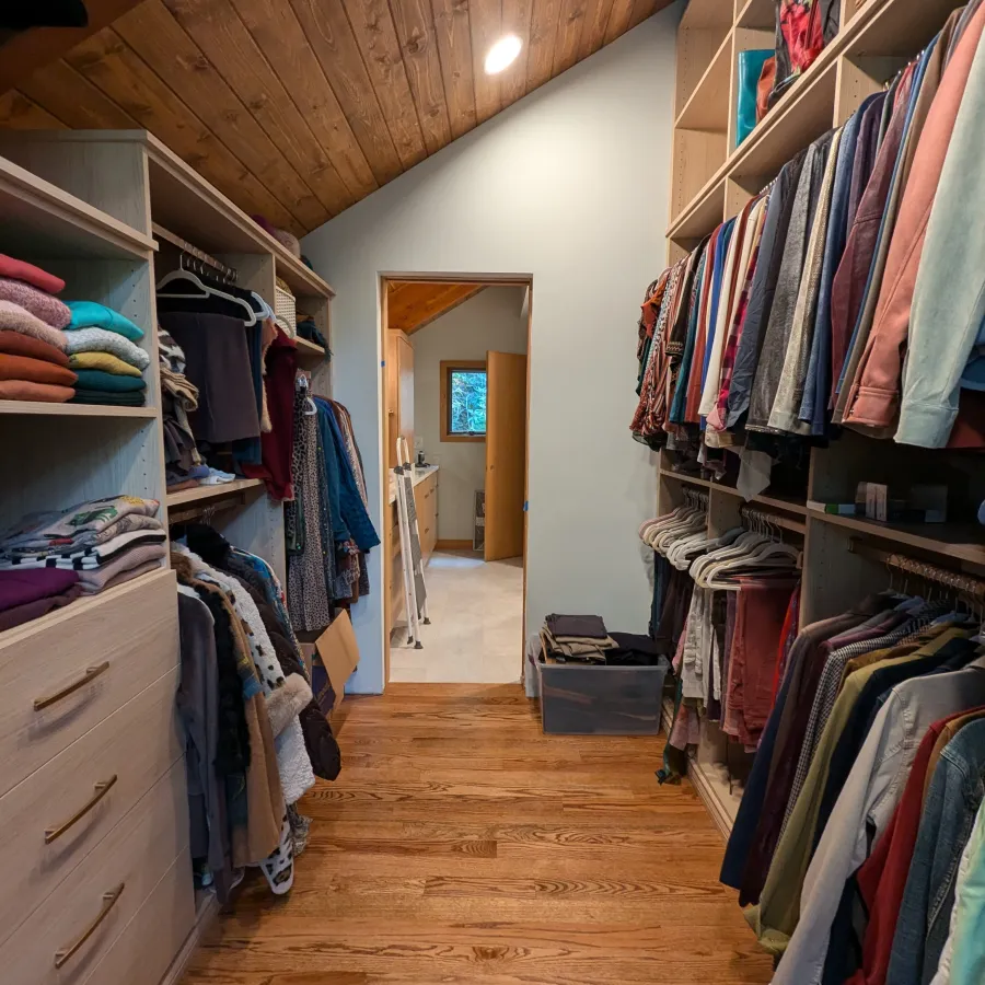 a room with a closet and clothes