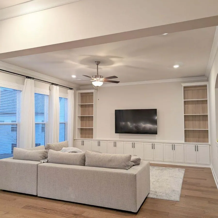 a living room with a white couch and a television