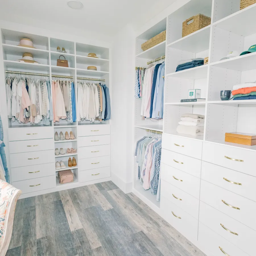 a closet with white drawers