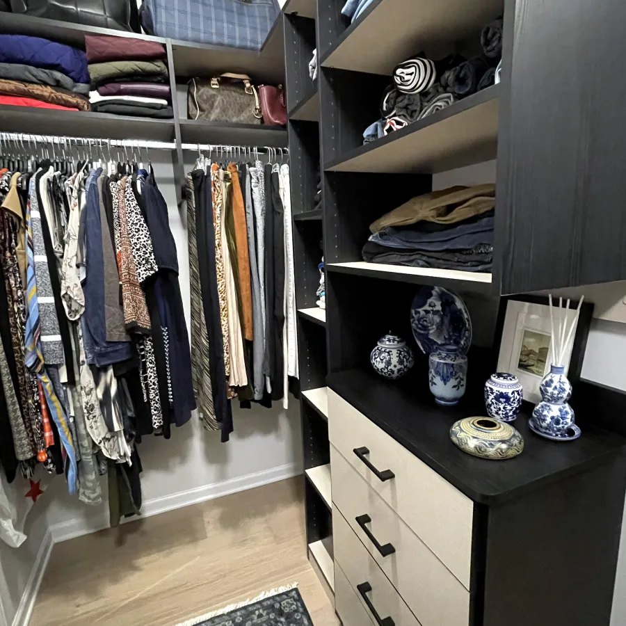 a closet with clothes and shoes