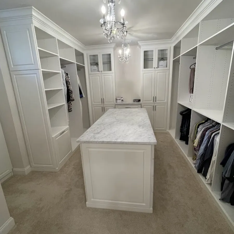 a room with a white counter and white cabinets